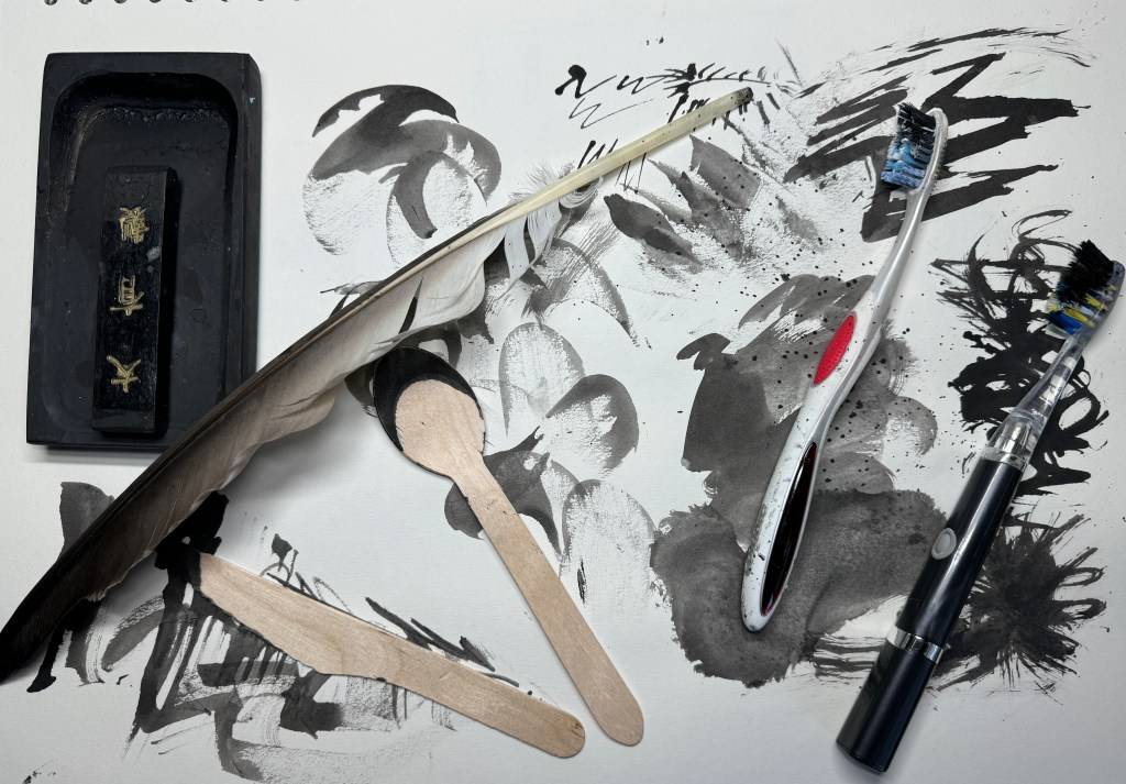 Image - Mark making examples using wooden cutlery, a feather and tooth brushes.